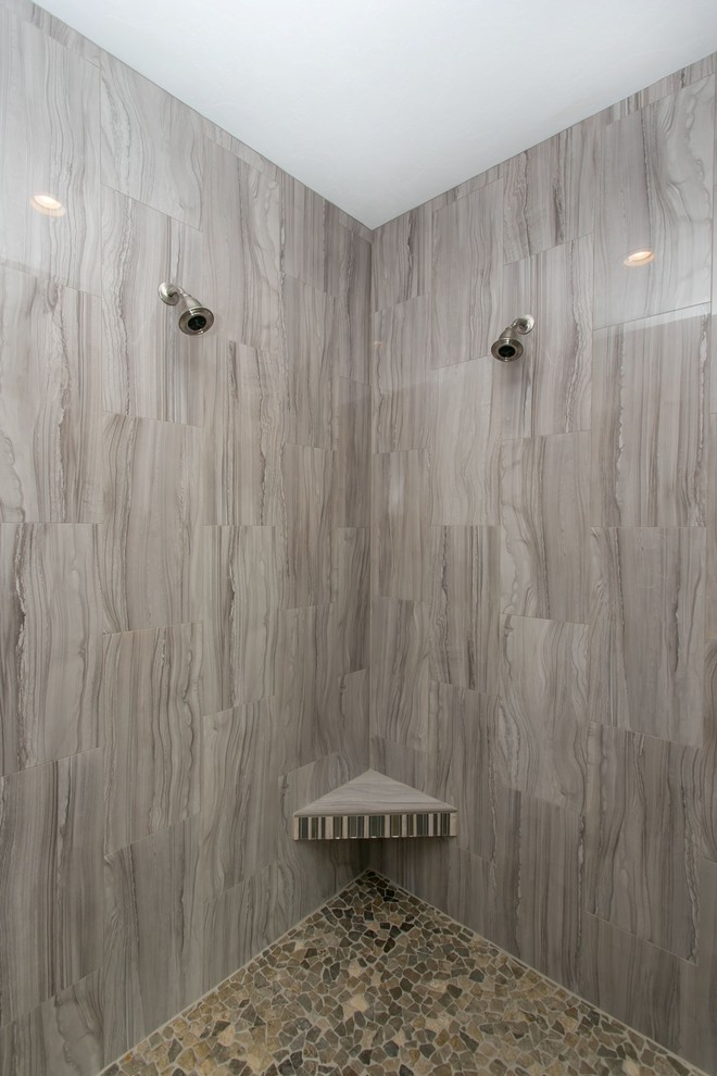 Large transitional master gray tile and glass tile porcelain tile and gray floor corner bathtub photo in Seattle with shaker cabinets, dark wood cabinets, a two-piece toilet, gray walls, an undermount sink, quartz countertops and white countertops