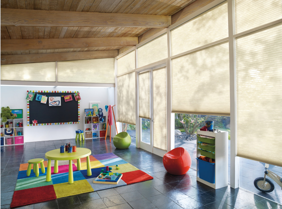 Large traditional gender-neutral kids' room in Albuquerque with white walls and slate floors.