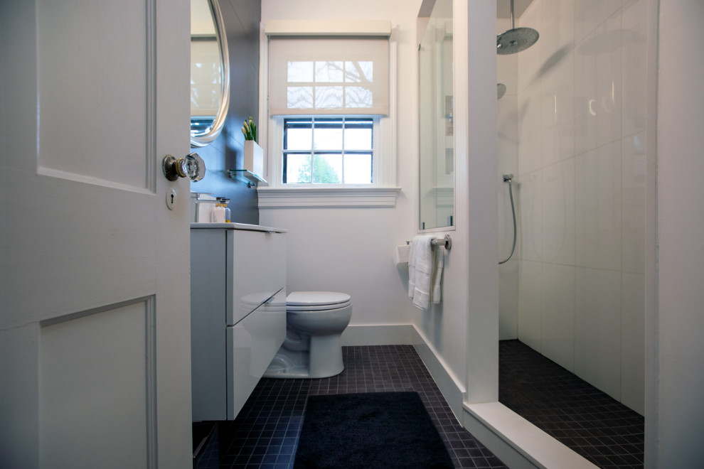 Example of a small minimalist 3/4 white tile and porcelain tile ceramic tile, gray floor, single-sink, tray ceiling and wainscoting corner shower design in Baltimore with flat-panel cabinets, white cabinets, a two-piece toilet, gray walls, a wall-mount sink, solid surface countertops, white countertops and a floating vanity