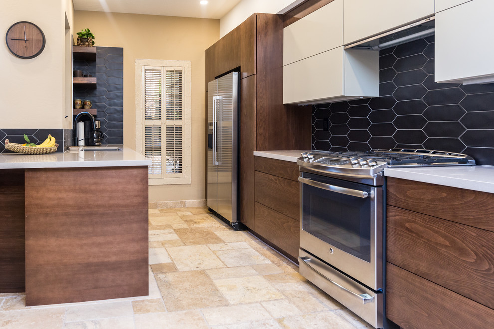 Design ideas for a large contemporary l-shaped open plan kitchen in Phoenix with an undermount sink, flat-panel cabinets, white cabinets, quartz benchtops, black splashback, stainless steel appliances, travertine floors, a peninsula, beige floor and white benchtop.