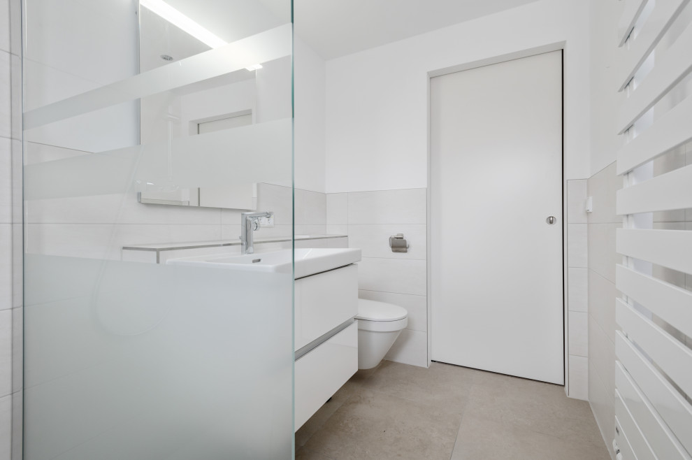 Photo of a traditional 3/4 bathroom in Munich with white cabinets, a curbless shower, white tile, wood benchtops, an open shower, a single vanity and a floating vanity.