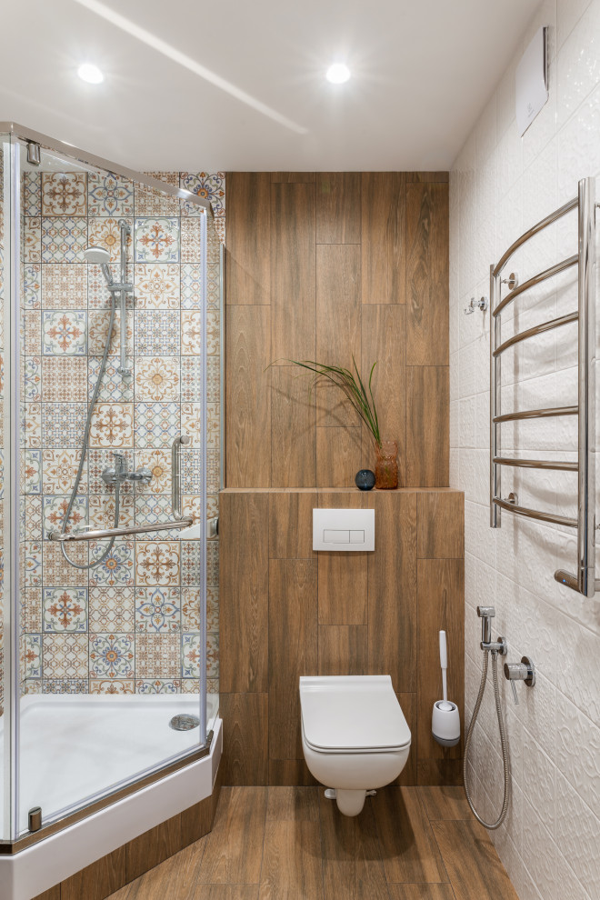 Small mediterranean 3/4 bathroom in Other with flat-panel cabinets, light wood cabinets, a corner shower, a wall-mount toilet, multi-coloured tile, ceramic tile, porcelain floors, brown floor, a hinged shower door, white benchtops, a single vanity and a floating vanity.