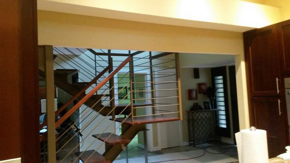 Example of a mid-sized mountain style wooden u-shaped mixed material railing staircase design in Austin with metal risers