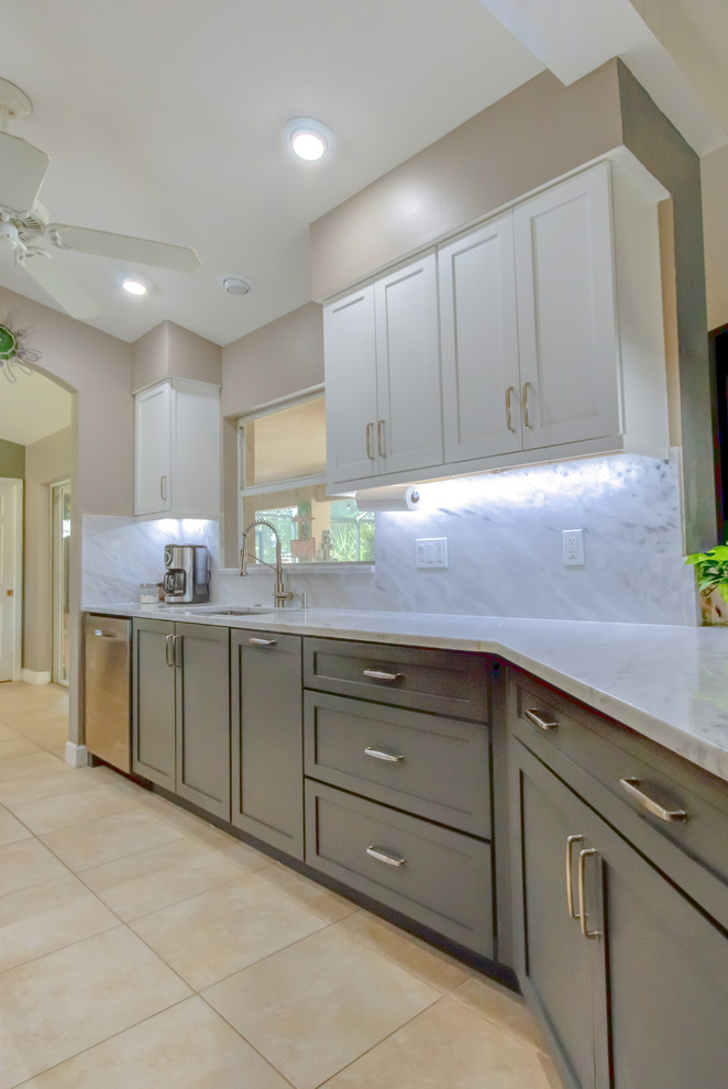 Kitchen pantry - mid-sized contemporary galley kitchen pantry idea with shaker cabinets, white cabinets, quartz countertops, a peninsula, an undermount sink, white backsplash, stone slab backsplash, stainless steel appliances and white countertops