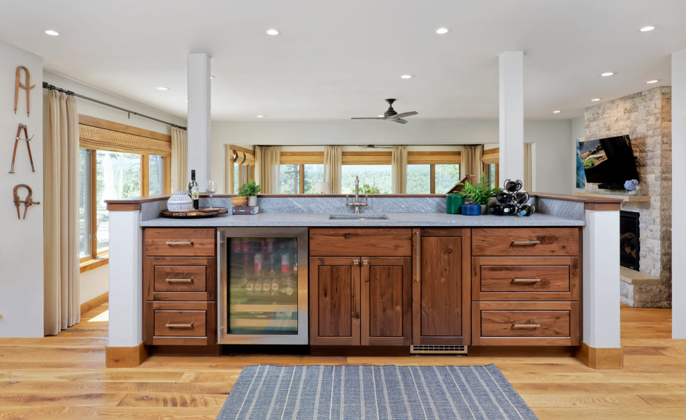 Inspiration for a mid-sized country l-shaped open plan kitchen in Denver with an undermount sink, shaker cabinets, granite benchtops, beige splashback, stainless steel appliances, medium hardwood floors and with island.
