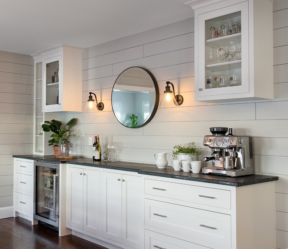 Inspiration for a large transitional galley eat-in kitchen in Boston with a farmhouse sink, shaker cabinets, white cabinets, soapstone benchtops, white splashback, ceramic splashback, stainless steel appliances, dark hardwood floors, with island, brown floor and multi-coloured benchtop.