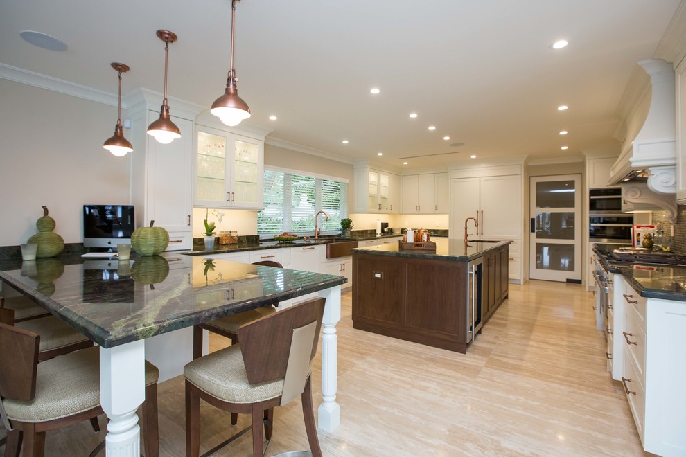 Inspiration for a large transitional u-shaped light wood floor open concept kitchen remodel in Miami with a farmhouse sink, shaker cabinets, stainless steel appliances, an island, granite countertops, white cabinets, metallic backsplash and mosaic tile backsplash