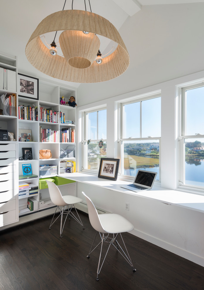 This is an example of a contemporary home office in Providence with white walls, dark hardwood floors and a built-in desk.