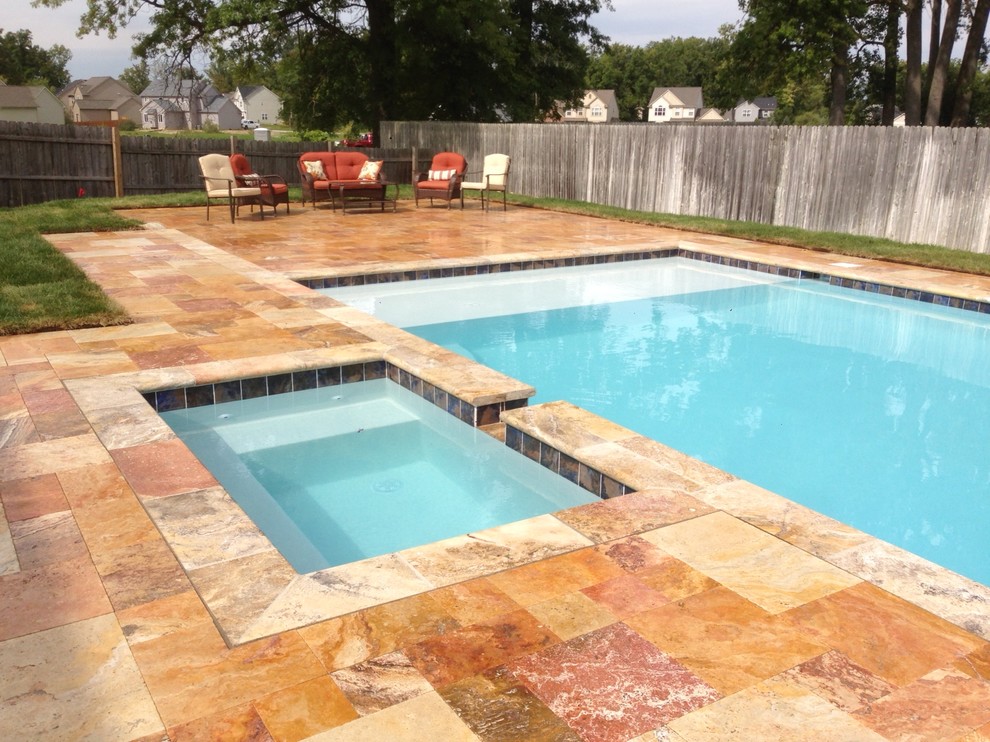 This is an example of a mid-sized contemporary backyard rectangular pool in Detroit with a hot tub and tile.