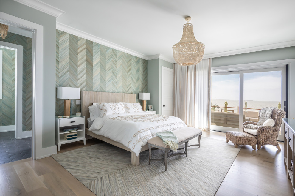 Inspiration for a beach style bedroom in New York with green walls, medium hardwood floors, brown floor and wallpaper.