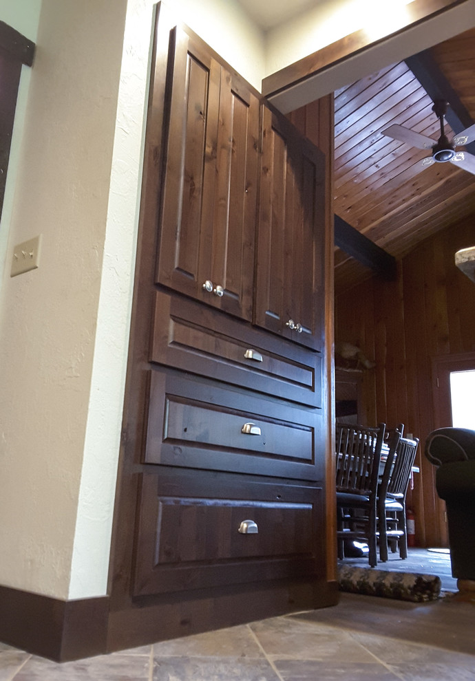 Inspiration for a mid-sized rustic galley slate floor and beige floor kitchen pantry remodel with raised-panel cabinets, dark wood cabinets, granite countertops, an undermount sink, stainless steel appliances and no island