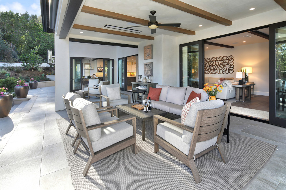 Mediterranean patio in Orange County with a roof extension.