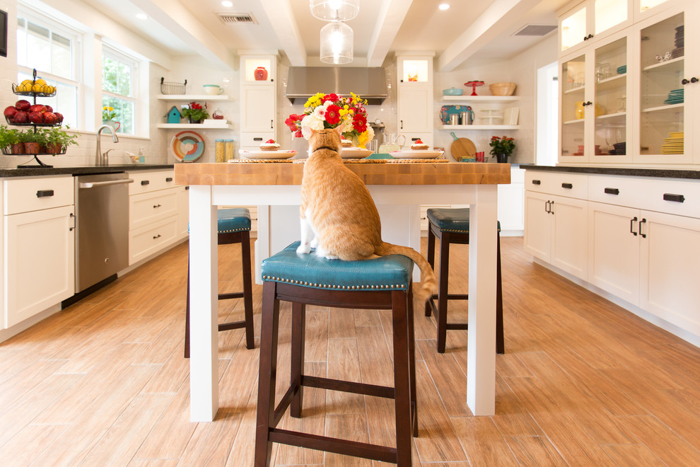 Kitchen pantry - mid-sized craftsman u-shaped ceramic tile and brown floor kitchen pantry idea in Phoenix with a double-bowl sink, shaker cabinets, white cabinets, wood countertops, white backsplash, subway tile backsplash, stainless steel appliances and an island