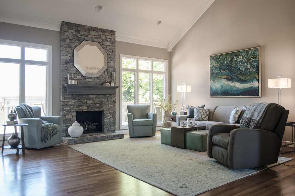 Large transitional open concept living room in Louisville with grey walls, medium hardwood floors, a standard fireplace, a stone fireplace surround, a freestanding tv and orange floor.