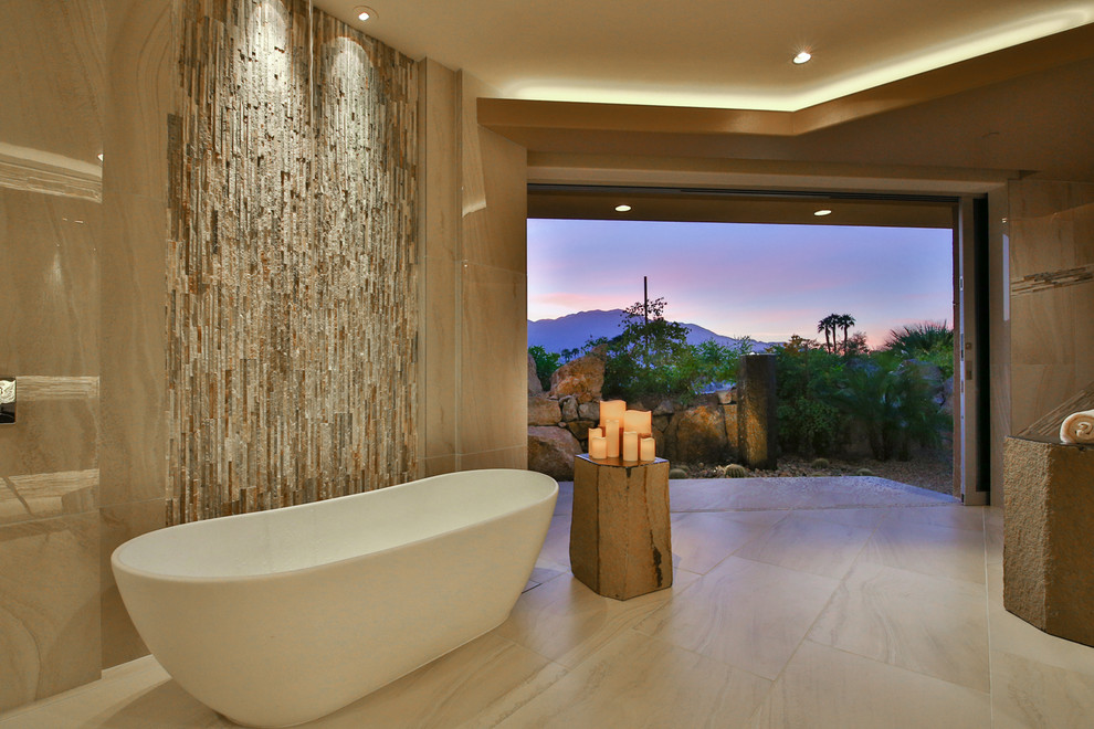 Photo of an expansive contemporary master bathroom in Los Angeles with a freestanding tub, porcelain floors, beige tile, stone tile, beige walls, beige floor, an open shower and an open shower.