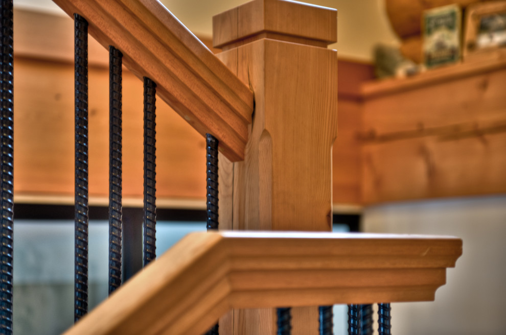 This is an example of a mid-sized country wood l-shaped staircase in Vancouver with open risers and metal railing.