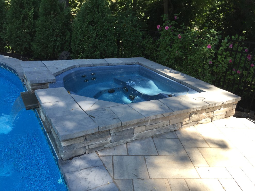 Inspiration for a traditional backyard kidney-shaped pool in New York with a hot tub.