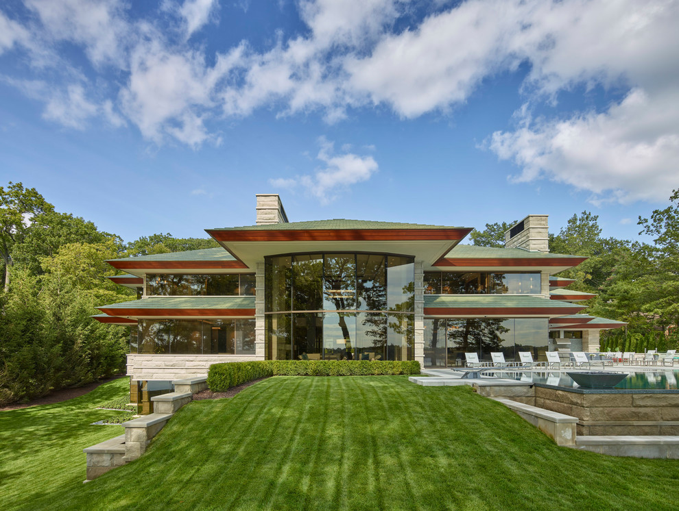 Midcentury two-storey glass house exterior in Detroit with a hip roof.
