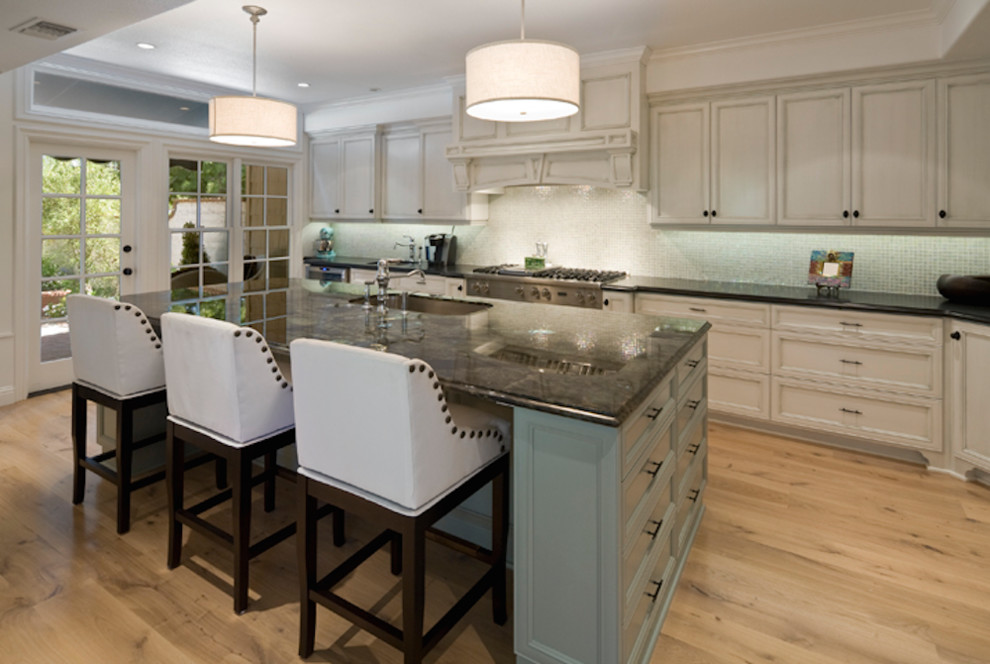 This is an example of a mid-sized contemporary galley eat-in kitchen in Orange County with with island.