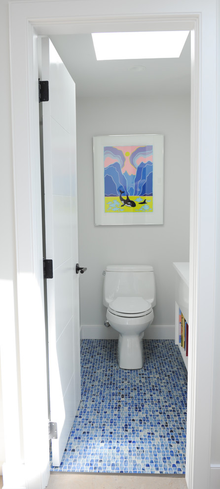 Design ideas for a small contemporary powder room in Vancouver with open cabinets, white cabinets, a one-piece toilet, engineered quartz benchtops, white walls, mosaic tile floors and a drop-in sink.