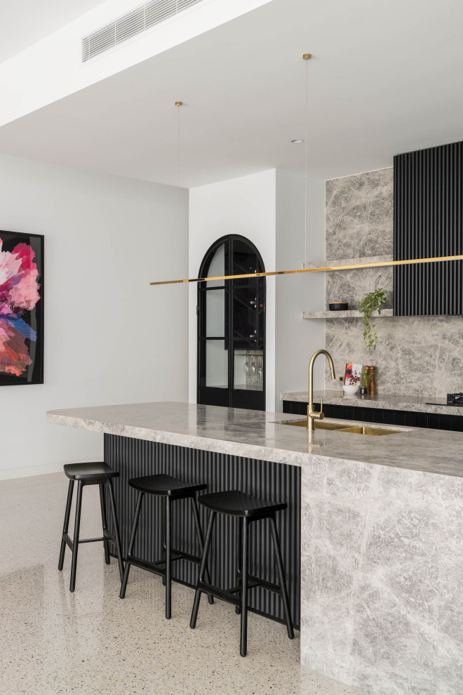 Inspiration for a large contemporary l-shaped open plan kitchen in Melbourne with a double-bowl sink, black cabinets, marble benchtops, grey splashback, marble splashback, black appliances, concrete floors, with island, grey floor and grey benchtop.