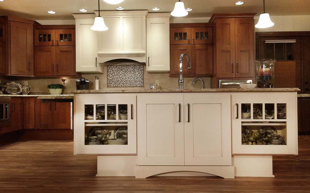 Open concept kitchen - large transitional l-shaped medium tone wood floor open concept kitchen idea with an undermount sink, shaker cabinets, medium tone wood cabinets, granite countertops, beige backsplash, ceramic backsplash, white appliances and an island
