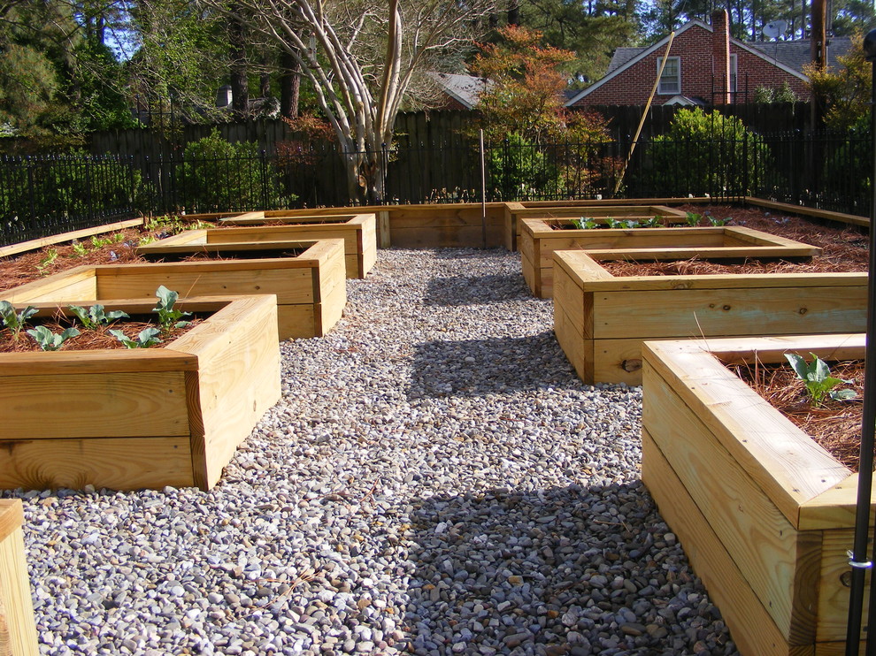 Photo of a large traditional backyard partial sun garden for fall in Other with a vegetable garden and gravel.