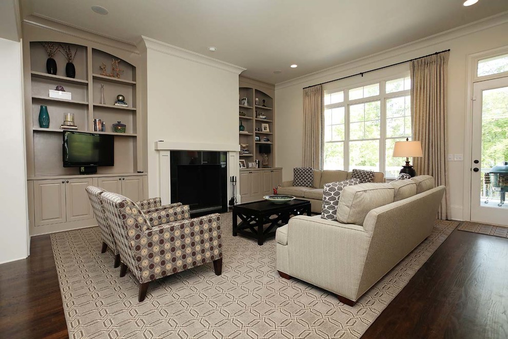 Design ideas for a large traditional open concept living room in Charlotte with beige walls, dark hardwood floors, a standard fireplace, a wood fireplace surround and no tv.