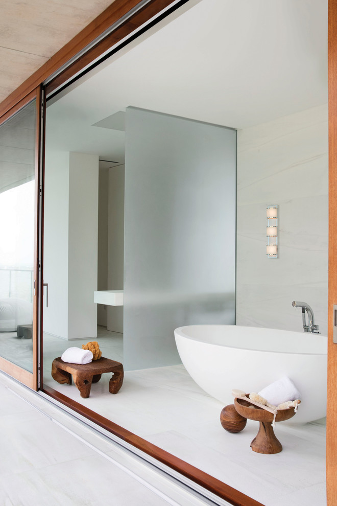 Design ideas for a large asian master bathroom in Chicago with open cabinets, a japanese tub, white walls, porcelain floors and white floor.