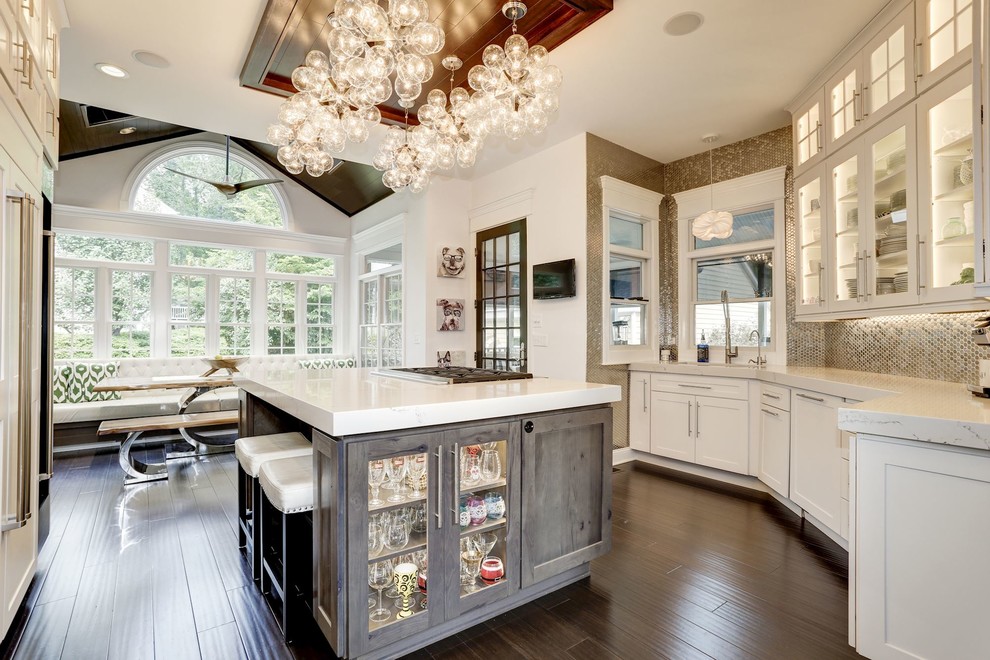 Inspiration for a mid-sized transitional u-shaped eat-in kitchen in Baltimore with white cabinets, metallic splashback, metal splashback, dark hardwood floors, with island, brown floor, an undermount sink, onyx benchtops, stainless steel appliances, white benchtop and shaker cabinets.