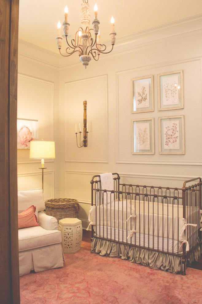This is an example of a mid-sized transitional nursery for girls in New Orleans with white walls and carpet.