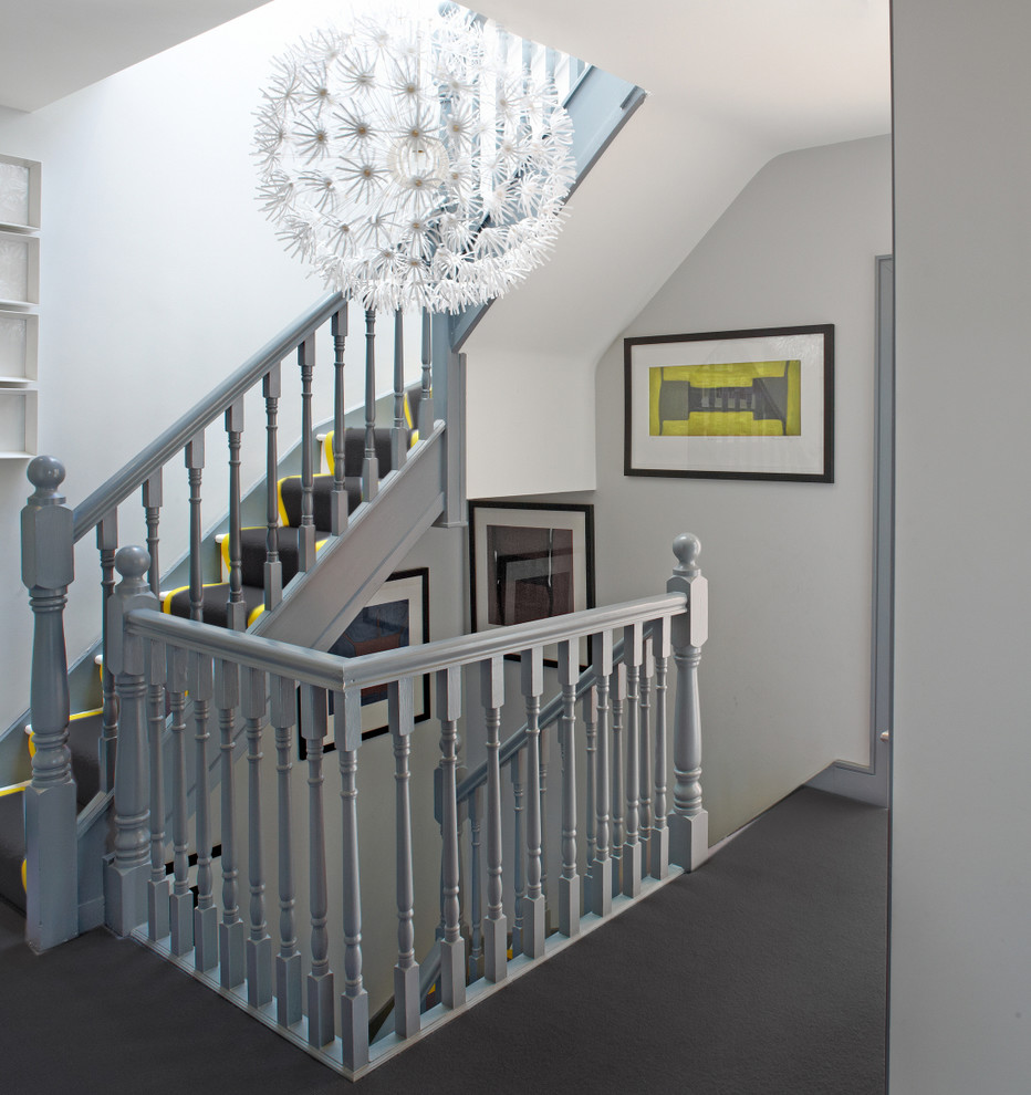 This is an example of a contemporary painted wood l-shaped staircase in Dublin with painted wood risers.