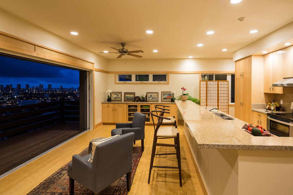 Asian galley eat-in kitchen in Hawaii with flat-panel cabinets, light wood cabinets, light hardwood floors, a double-bowl sink, laminate benchtops and stainless steel appliances.