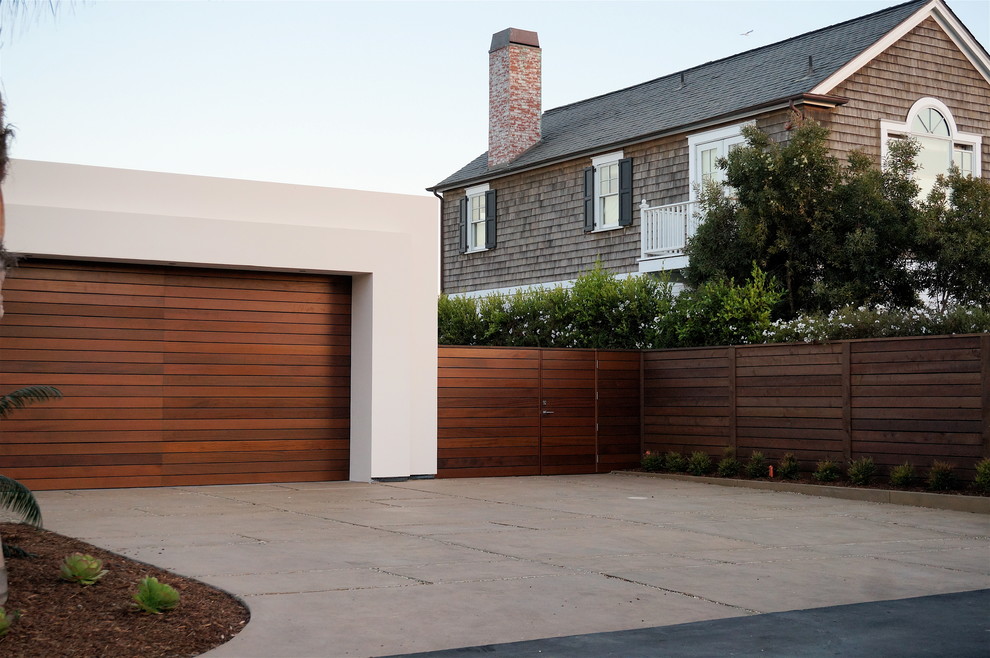 This is an example of a large modern front yard full sun driveway in Santa Barbara with a garden path and concrete pavers.