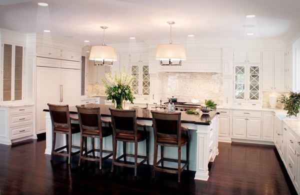 Kitchen - transitional dark wood floor kitchen idea with white cabinets, white backsplash and an island