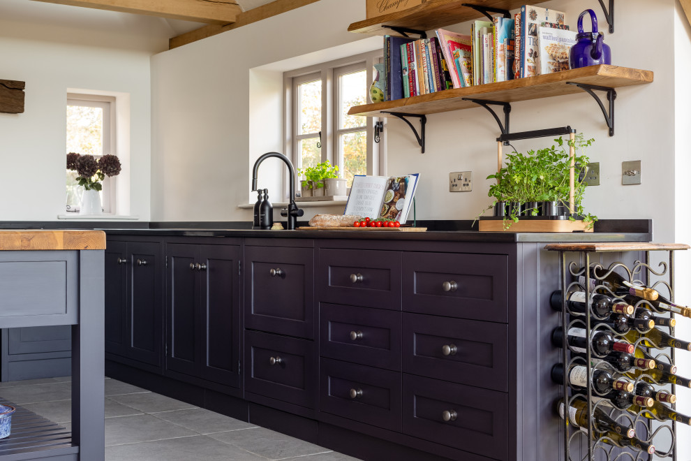 Example of a farmhouse kitchen design in Sussex with shaker cabinets