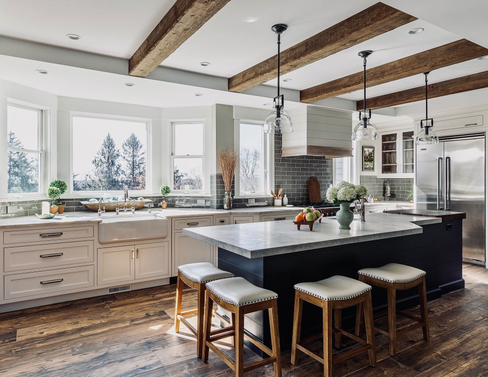 Photo of a large modern kitchen in Other with a farmhouse sink, beaded inset cabinets, white cabinets, granite benchtops, stainless steel appliances, with island, brown floor and white benchtop.