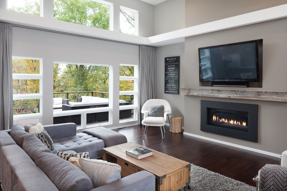 Design ideas for a contemporary living room in Minneapolis with grey walls, dark hardwood floors, a ribbon fireplace and a wall-mounted tv.