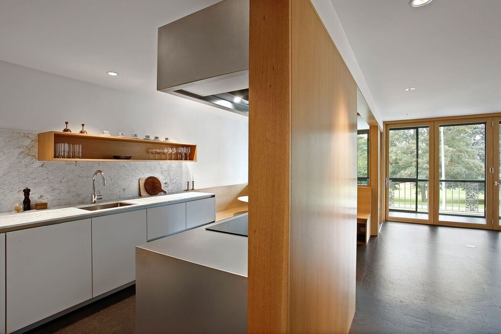 Photo of a mid-sized modern galley eat-in kitchen in Seattle with an undermount sink, flat-panel cabinets, white cabinets, quartz benchtops, multi-coloured splashback, ceramic splashback, stainless steel appliances, ceramic floors, a peninsula, brown floor and multi-coloured benchtop.
