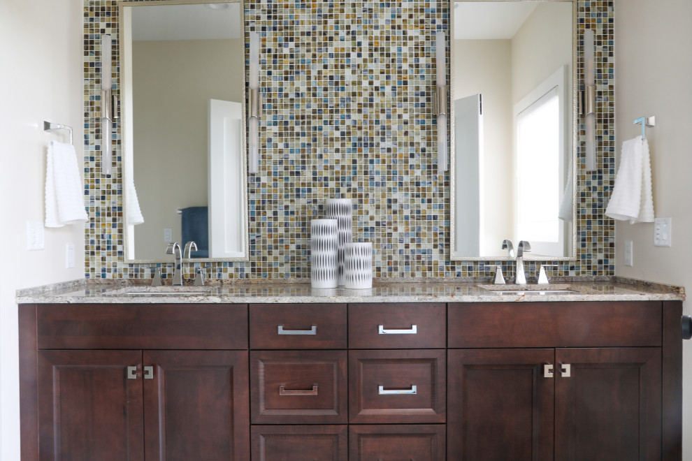 Photo of a large traditional master bathroom in Milwaukee with recessed-panel cabinets, dark wood cabinets, an undermount sink, granite benchtops, multi-coloured tile and mosaic tile.