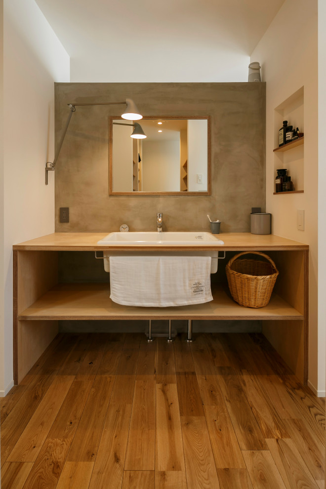 Medium sized industrial cloakroom in Other with open cabinets, grey tiles, grey walls, medium hardwood flooring, a submerged sink, wooden worktops, brown floors, brown worktops, feature lighting, a built in vanity unit, a wallpapered ceiling and wallpapered walls.