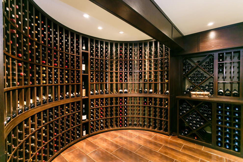 Large transitional wine cellar in New York with porcelain floors and display racks.