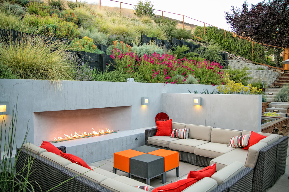 This is an example of a mid-sized contemporary backyard patio in San Francisco with a fire feature and concrete pavers.