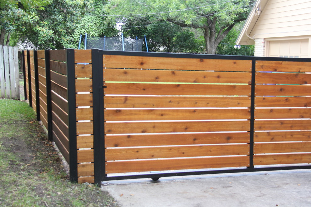 This is an example of a mid-sized modern full sun backyard driveway in Austin for spring.