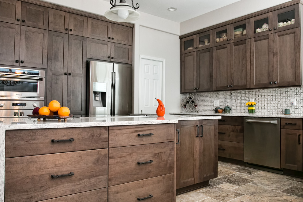 Kitchen - porcelain tile kitchen idea in Phoenix with an undermount sink, shaker cabinets, gray cabinets, quartz countertops, white backsplash, ceramic backsplash, stainless steel appliances and an island