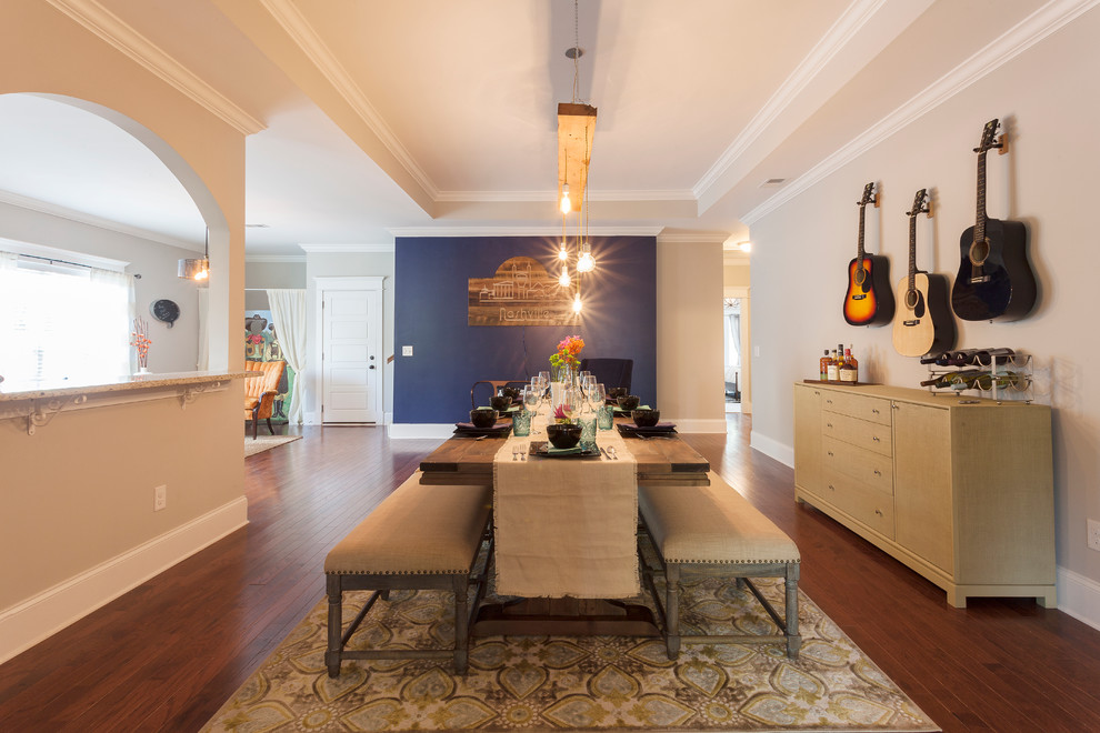 This is an example of a large transitional dining room in Nashville with blue walls and medium hardwood floors.