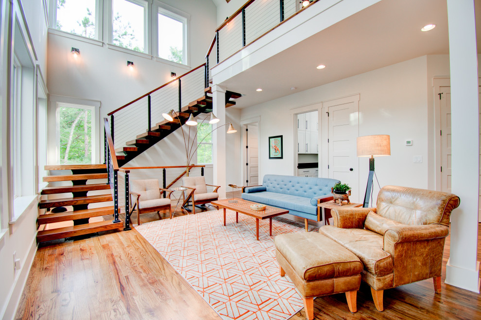 Example of a transitional formal and open concept medium tone wood floor and brown floor living room design in Atlanta with white walls, no fireplace and no tv