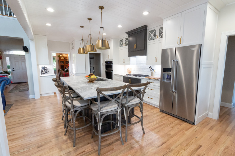 Large l-shaped eat-in kitchen photo with shaker cabinets, white cabinets, granite countertops, an island and white countertops