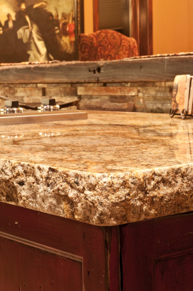 Large mountain style u-shaped slate floor home design photo in Denver with a farmhouse sink, raised-panel cabinets, medium tone wood cabinets, granite countertops, multicolored backsplash, colored appliances, brown walls and an island