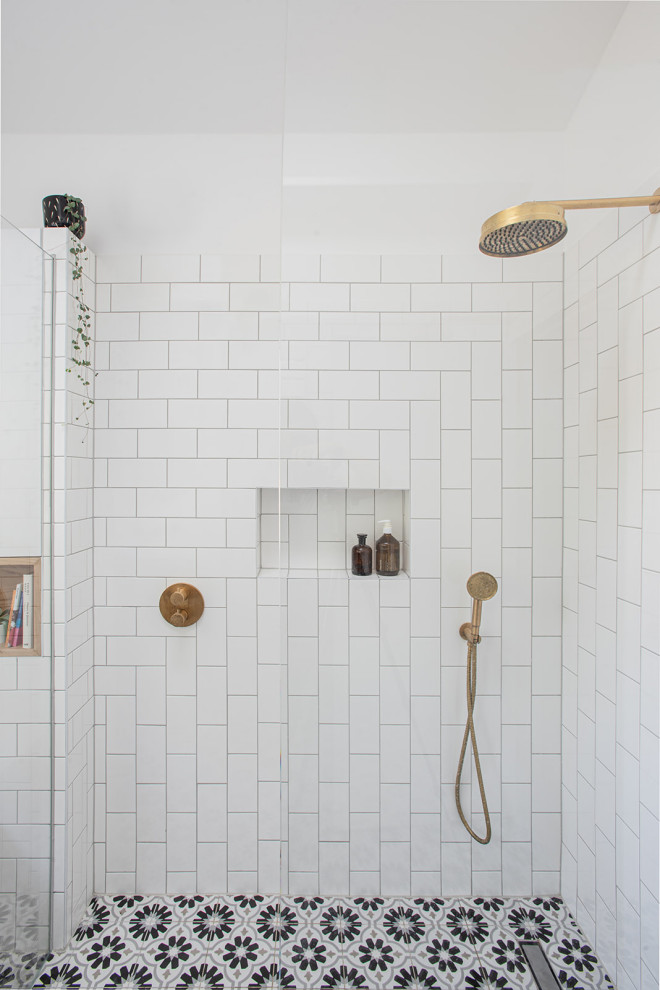 Exempel på ett mellanstort minimalistiskt grå grått badrum med dusch, med skåp i ljust trä, en öppen dusch, en vägghängd toalettstol, vit kakel, cementkakel, vita väggar, klinkergolv i keramik, ett konsol handfat, bänkskiva i betong, flerfärgat golv och med dusch som är öppen